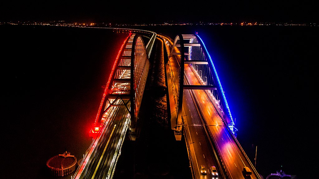 Крымский мост вечером 18 декабря 2019 года. Арки автомобильного (справа) и железнодорожного переходов с подсветкой. Фото: Росавтодор